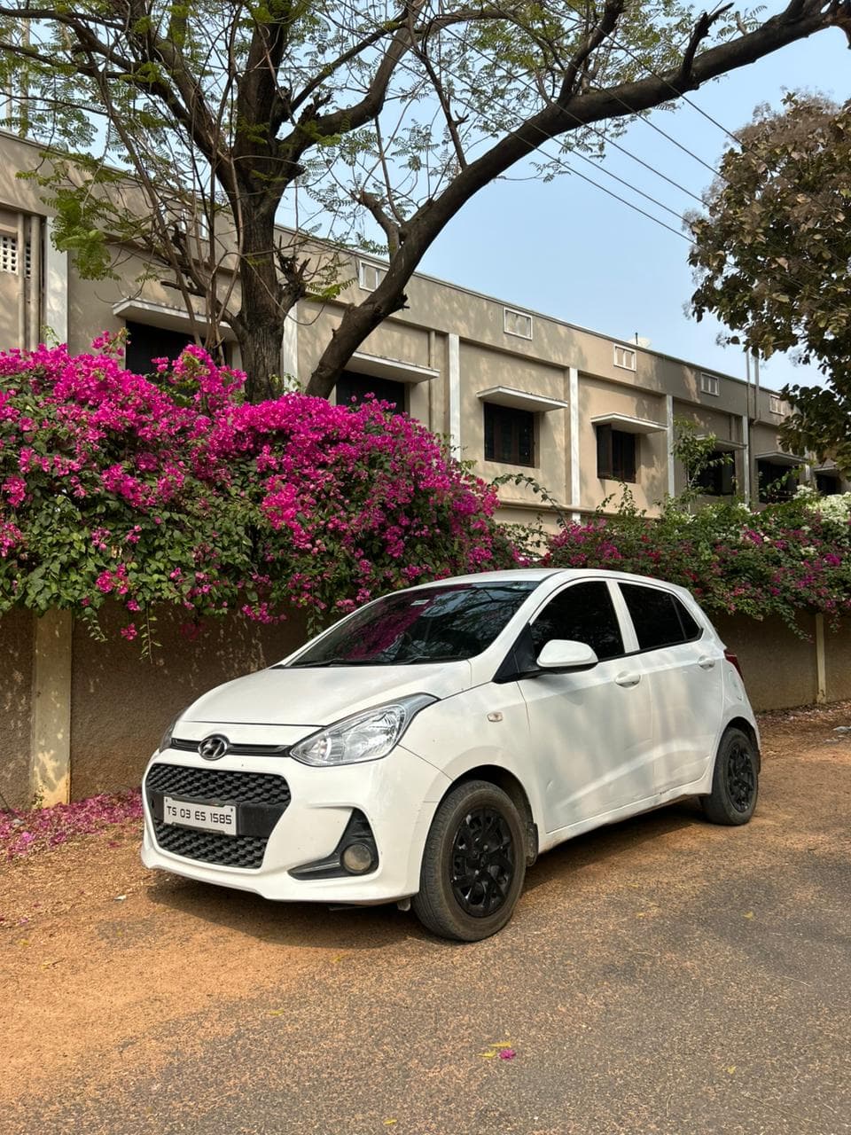 A photo of a Hyundai Grand i10 - White hatchback.