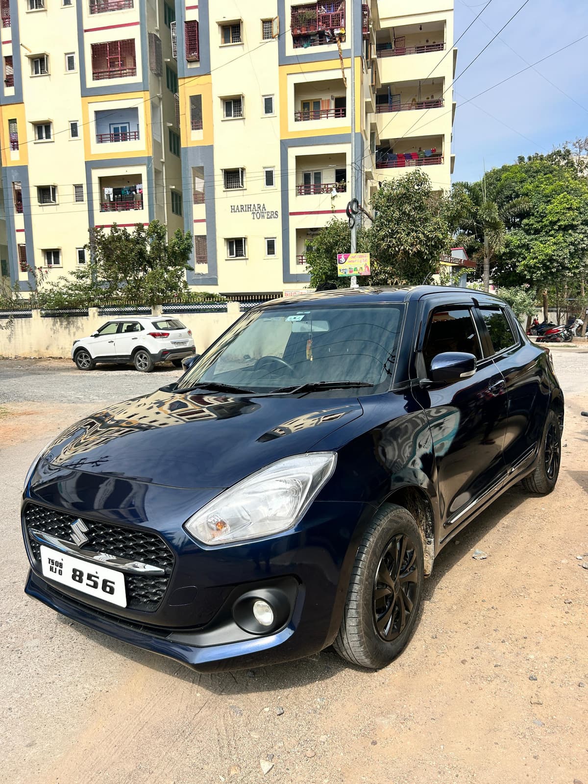 A photo of a Maruti Swift VXI 2022 - Blue hatchback.